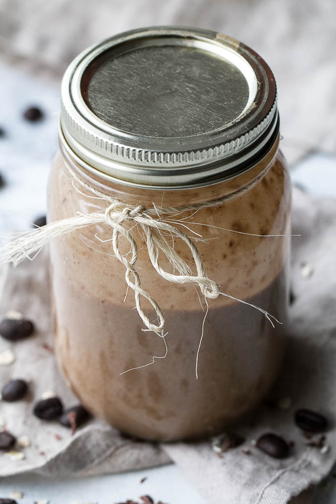 Coffee lovers rejoice! This creamy Banana Latte Overnight Oatmeal Smoothie combines that stick-to-your-ribs feeling of a bowl of oats with the silky smooth texture of a smoothie... plus your morning cup of coffee!! Vegan, gluten-free, and packed with plant-based protein and fiber, it makes a healthy and easy breakfast or afternoon snack! | runningwithspoons.com #recipe #coffee #smoothie #vegan