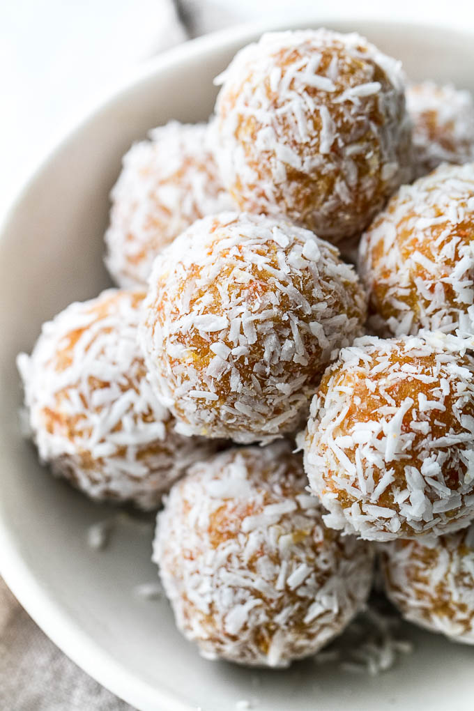 These Grain Free Carrot Cake Bites are paleo, vegan, refined sugar-free, and made with only 4 major ingredients! They're soft and doughy with a subtle sweetness and the perfect amount of spice. A perfect little healthy snack. | runningwithspoons.com #vegan #paleo #spring #glutenfree 
