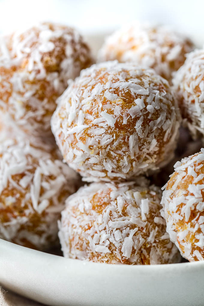 These Grain Free Carrot Cake Bites are paleo, vegan, refined sugar-free, and made with only 4 major ingredients! They're soft and doughy with a subtle sweetness and the perfect amount of spice. A perfect little healthy snack. | runningwithspoons.com #vegan #paleo #spring #glutenfree 