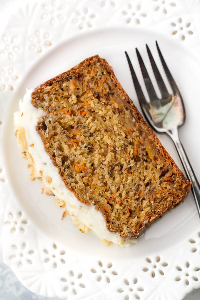 A slice of carrot cake banana bread on a plate with a fork.