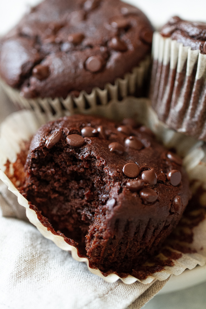 An easy vegan chocolate muffin with a bite taken out of it.
