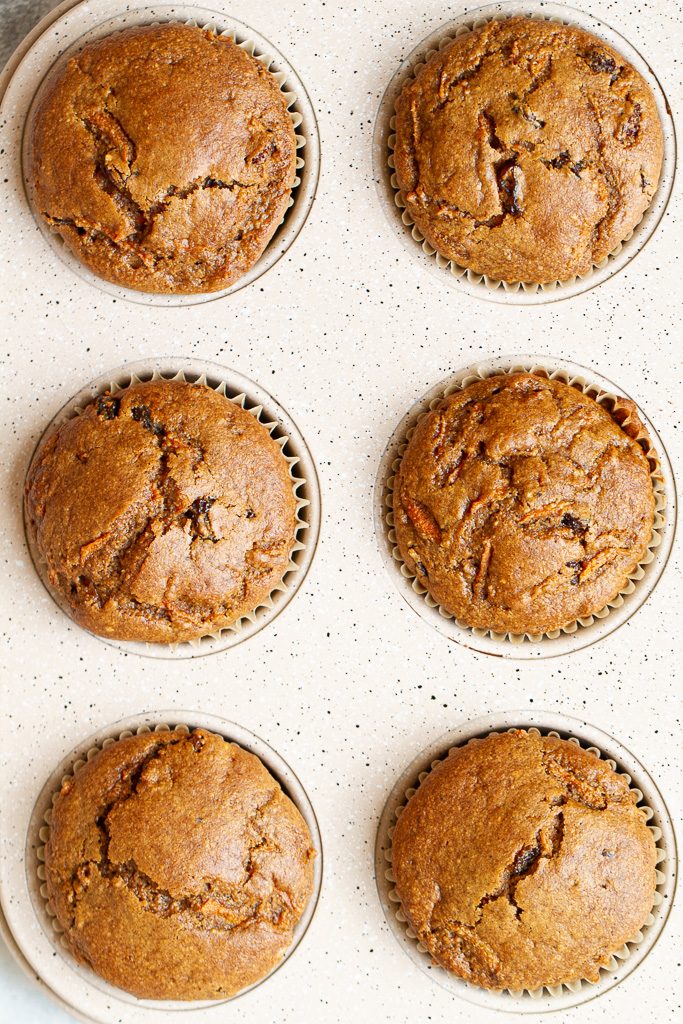 Flourless carrot cake muffins in a baking pan without any frosting.