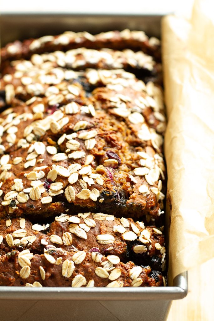 A closeup of blueberry banana bread in a bread pan.