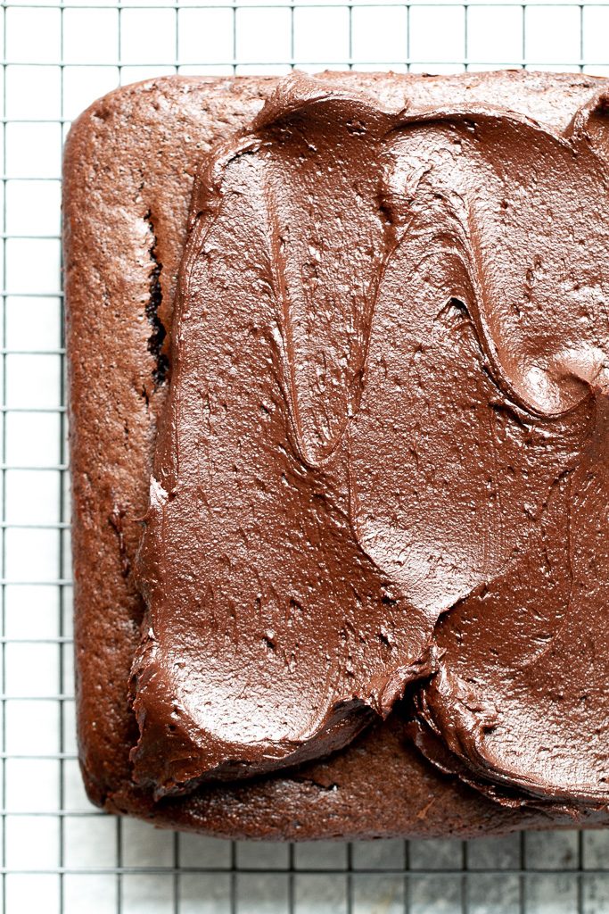 Easy chocolate sheet cake being frosted.