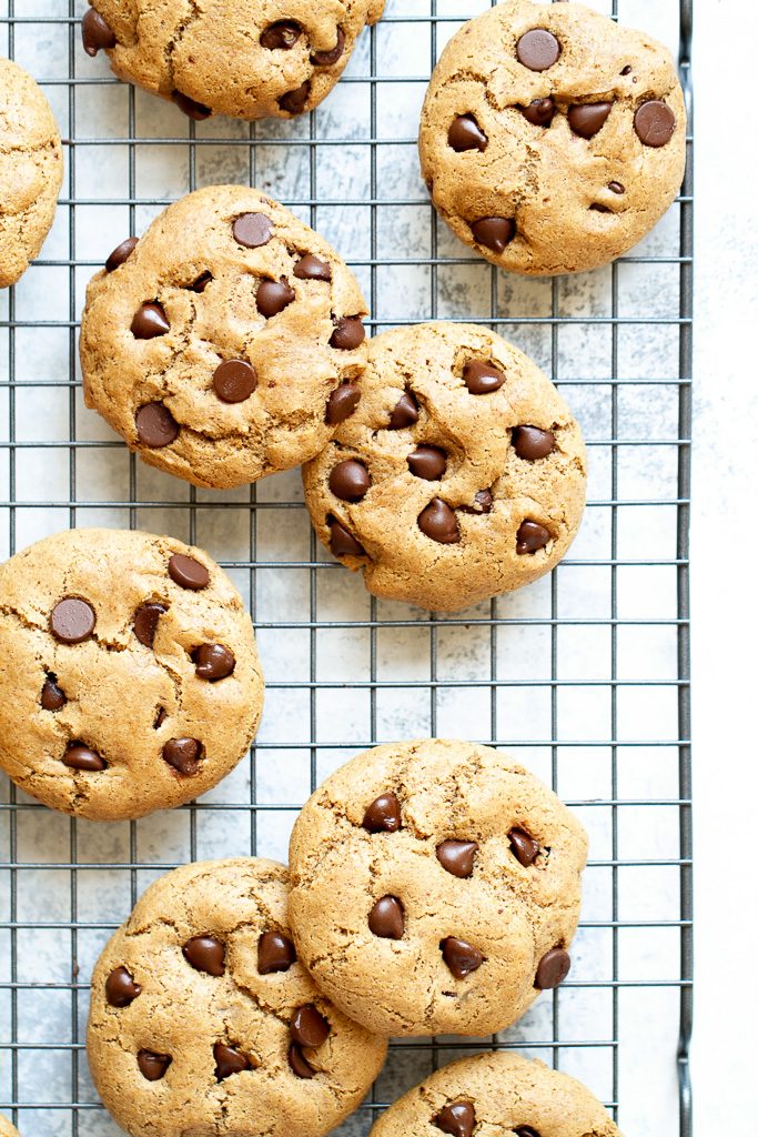 Flourless chocolate chip cookies on a cooling rack.